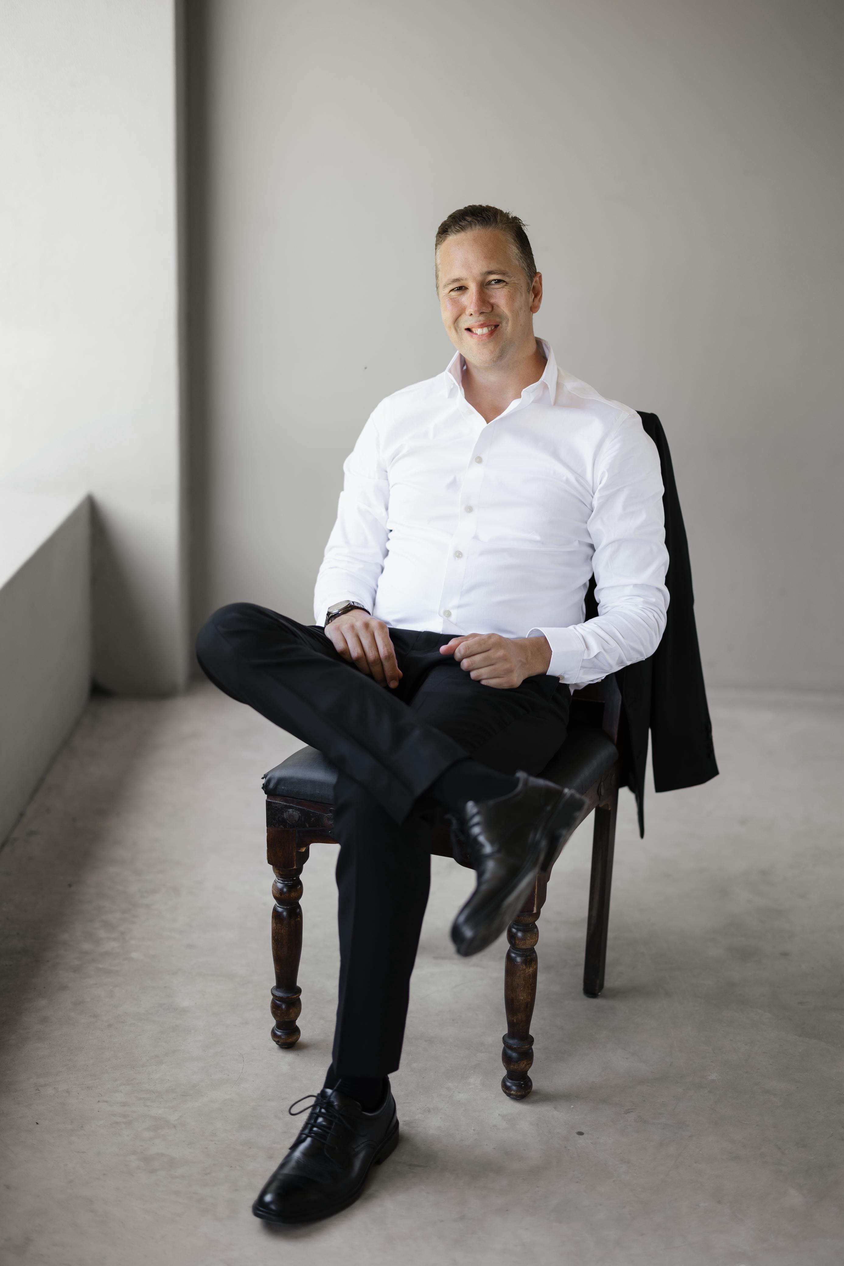 Alan Graysmark seated in a professional setting